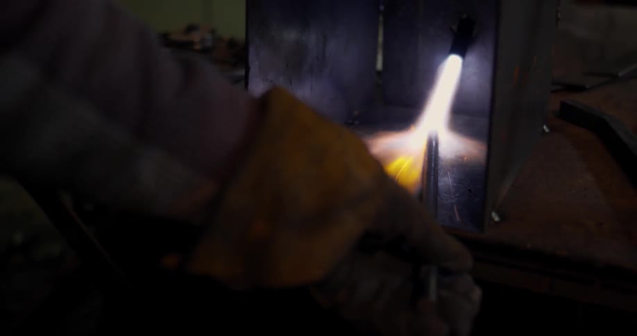 Long narrow tool held in a flame
