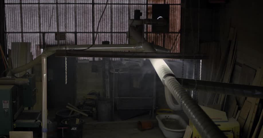 A shop light is on inside a workshop