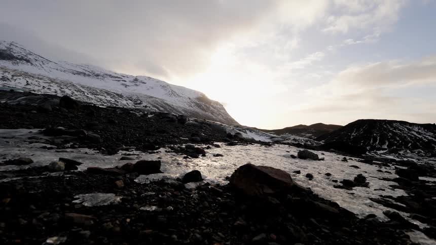 The sun shines on the frozen mountain