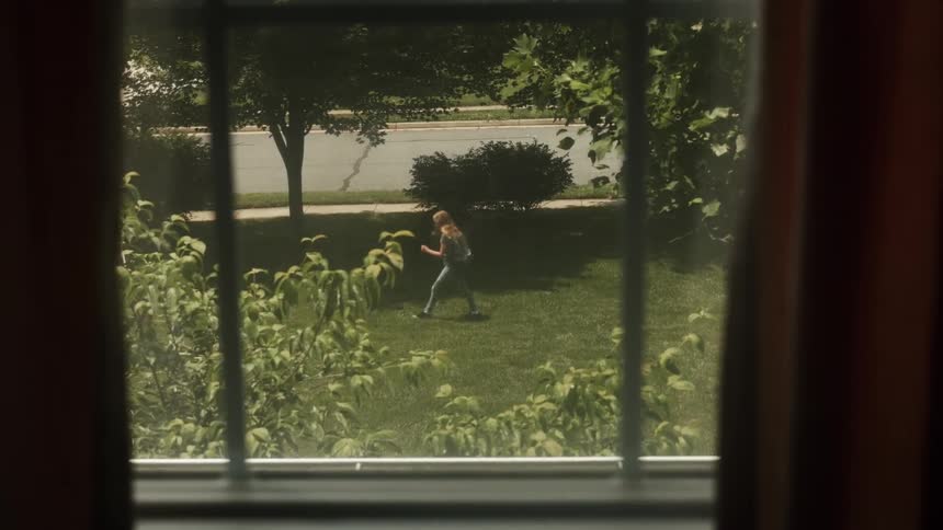 A young girl paces in the front yard