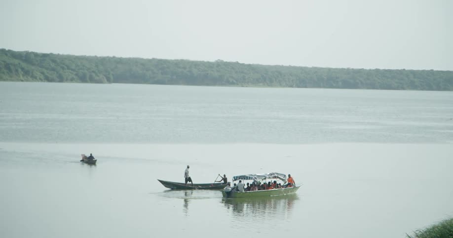 Boats are in the water moving on a cloudy day