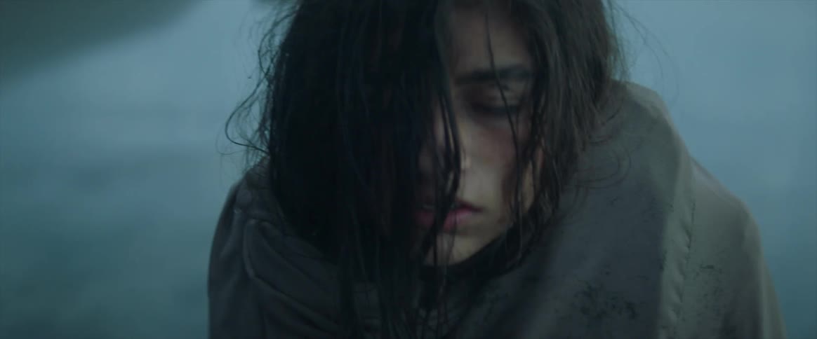Woman wrapped in a blanket outside in the cold falls over