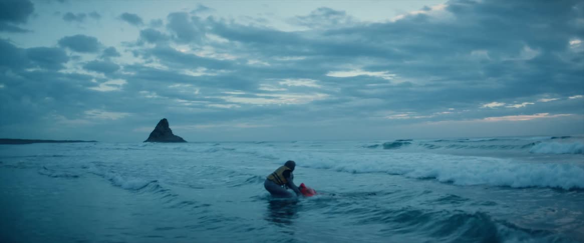 A woman tries to rescue a man drowning in the water