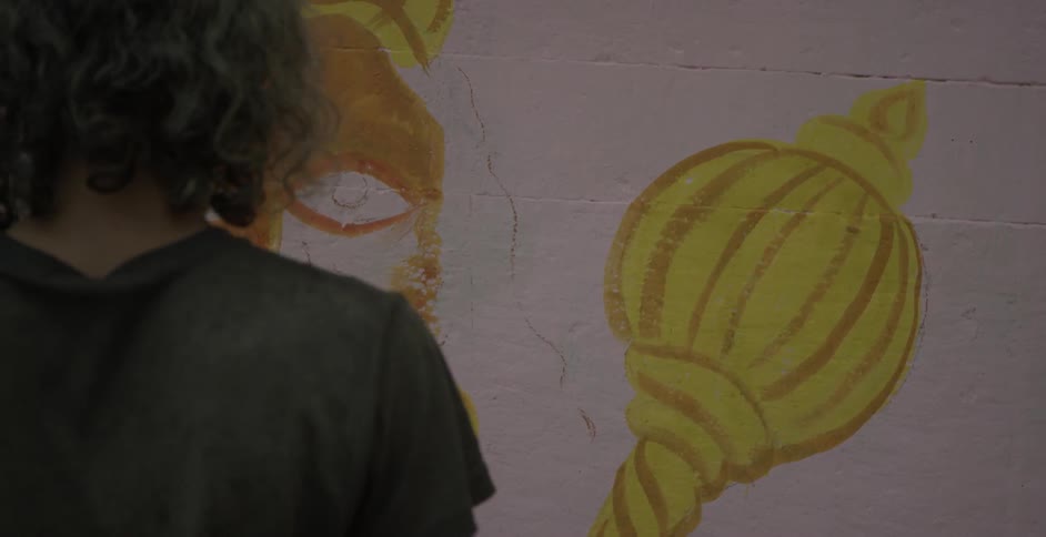 Man paints graffiti on a wall