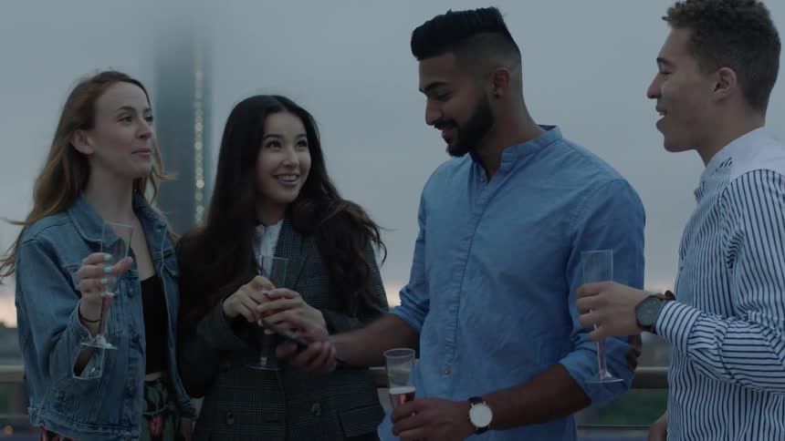 People are having fun drinking and talking on a rooftop