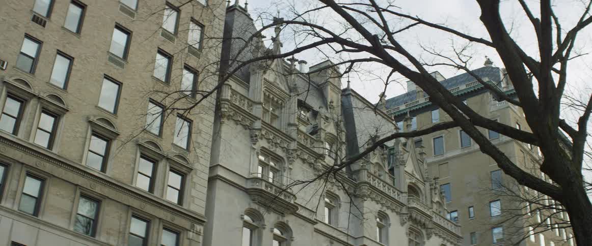 Three old buildings with trees in front