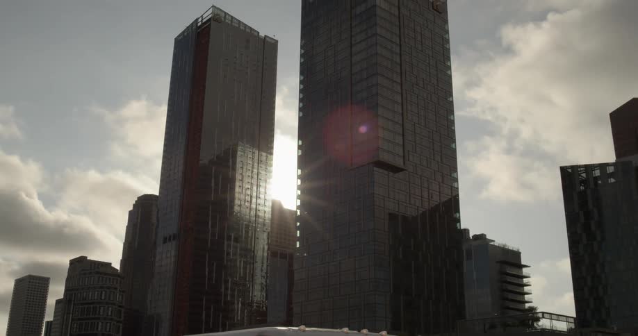 The city is full of dark shaded buildings that are tall