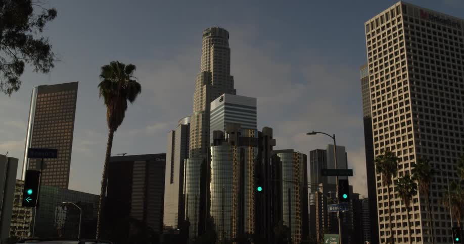 The city has tall towers with some street lights on the roads