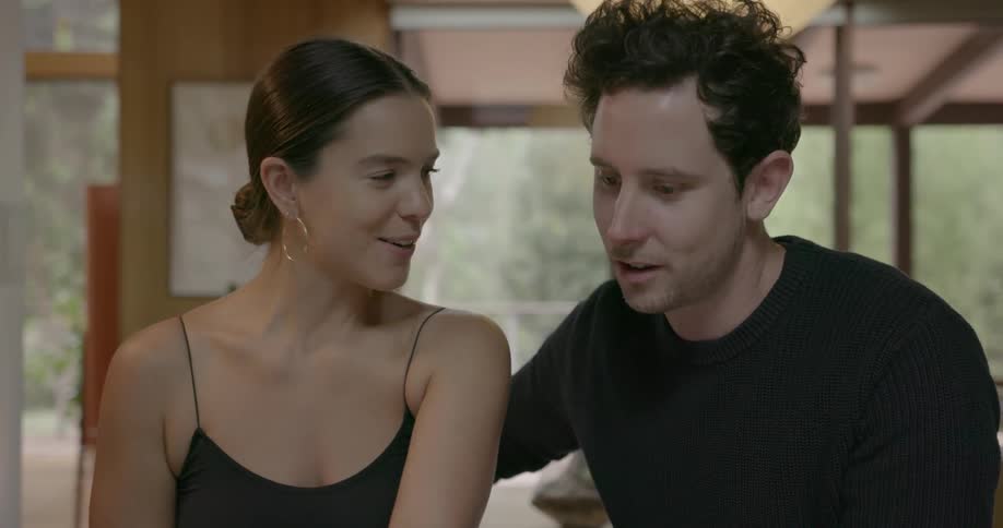 A man and woman talk and laugh