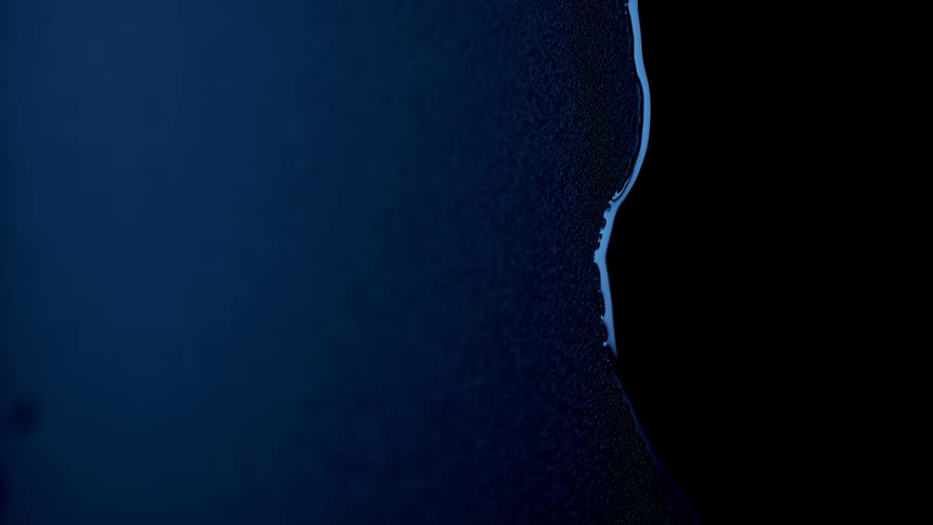 A trickle of water runs over a surface