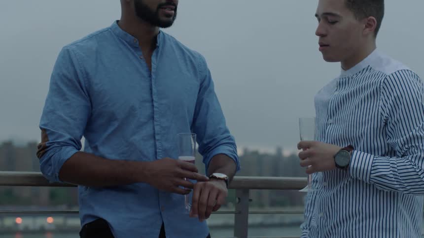 Men talk and drink outside