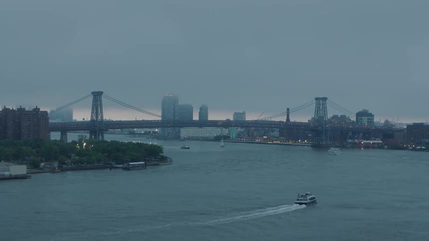 A boat sails in the water towards the city