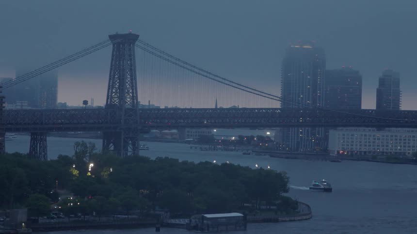 A heavy fog covers the bridge and city