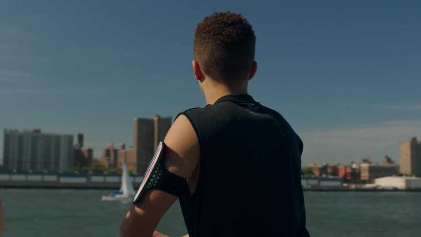 A man is stretching by the water