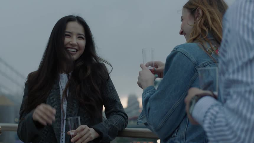 A group of people laugh and have some drinks
