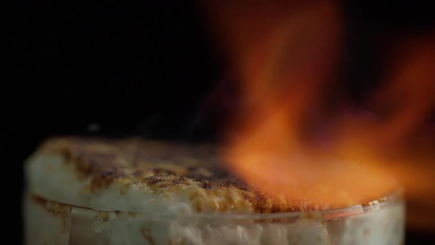 Fire spreads over the top of a marshmallow burning it black