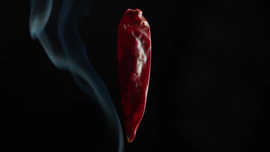 Smoke moves past a red object