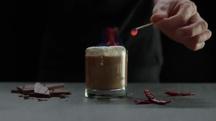 A person lights a chocolate drink on fire