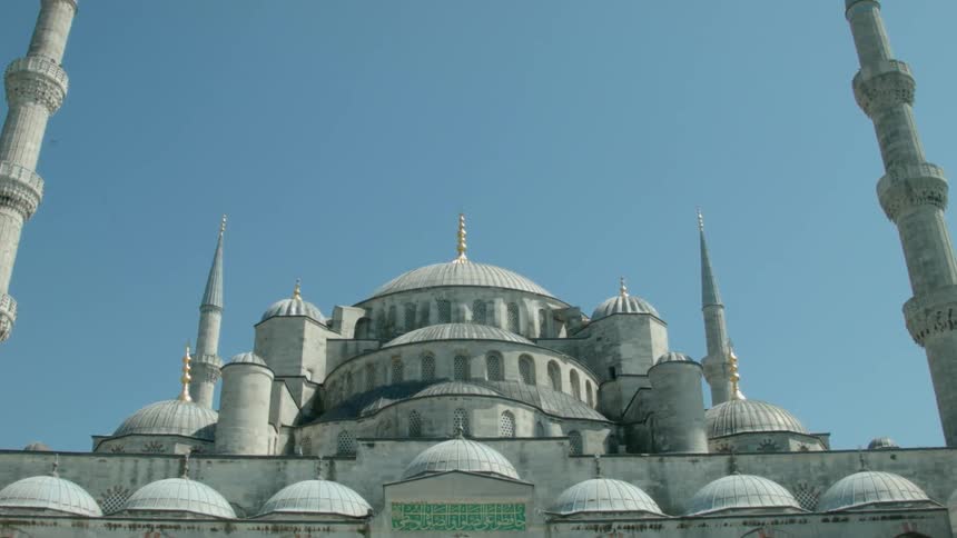 A large domed building is being filmed from the street
