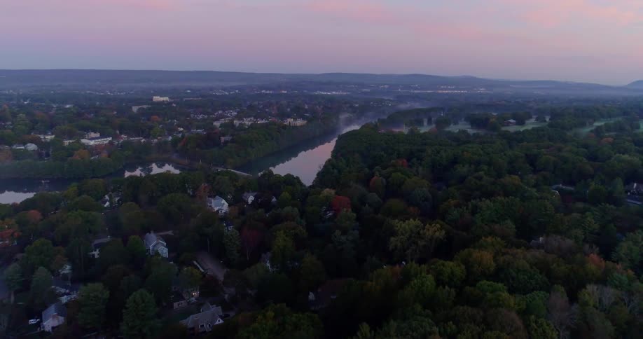 A neighborhood is shown at sunset