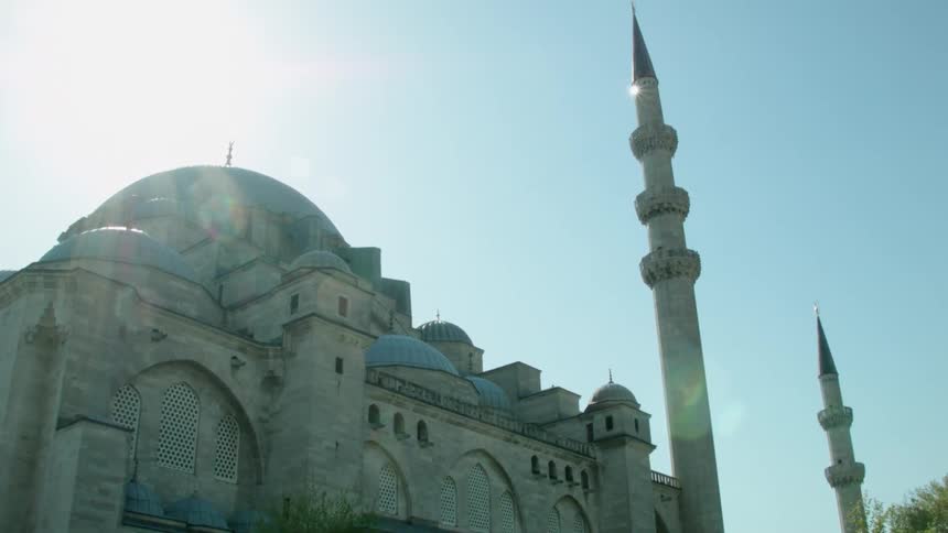 The sun shines brightly above a domed building
