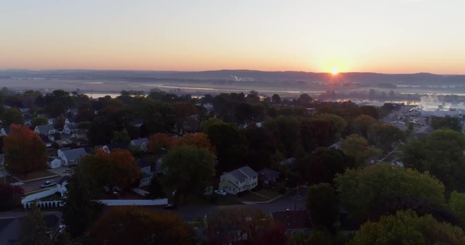 The sun sets over a neighborhood