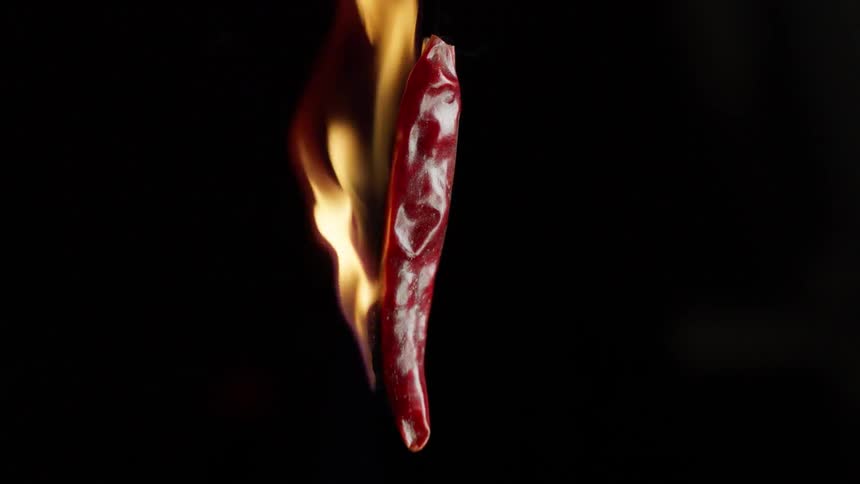 Flame engulfs a red chili pepper