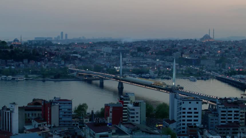 A bridge connects a city below