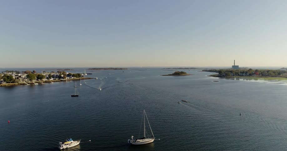 Sailboats travel along the waterway