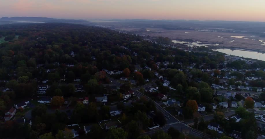 A wooded city near a body of water