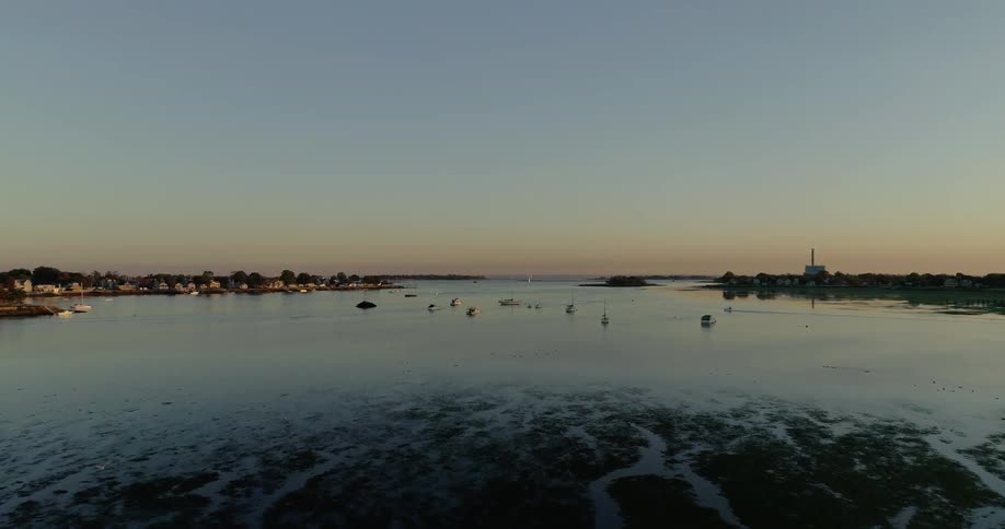 Boats are floating in the water by the town ahead