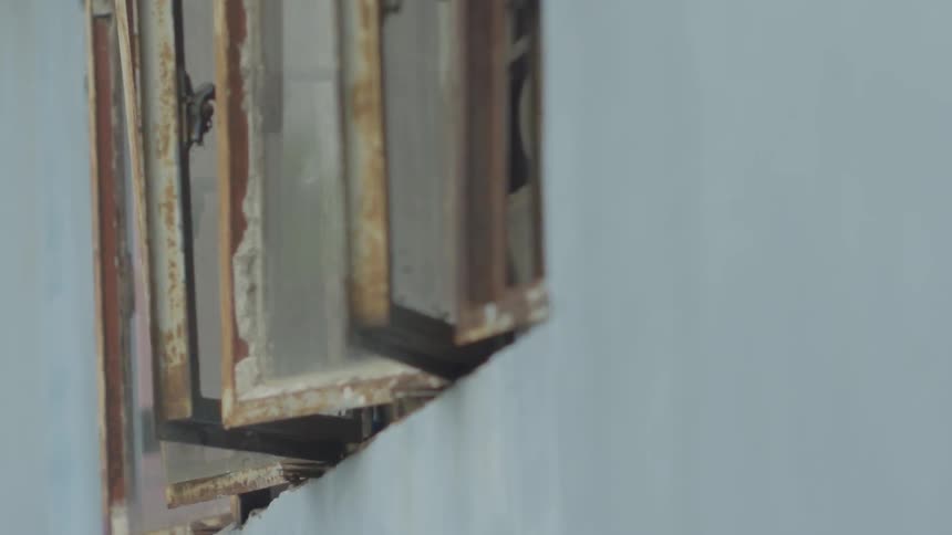 Rusty windows sit opened
