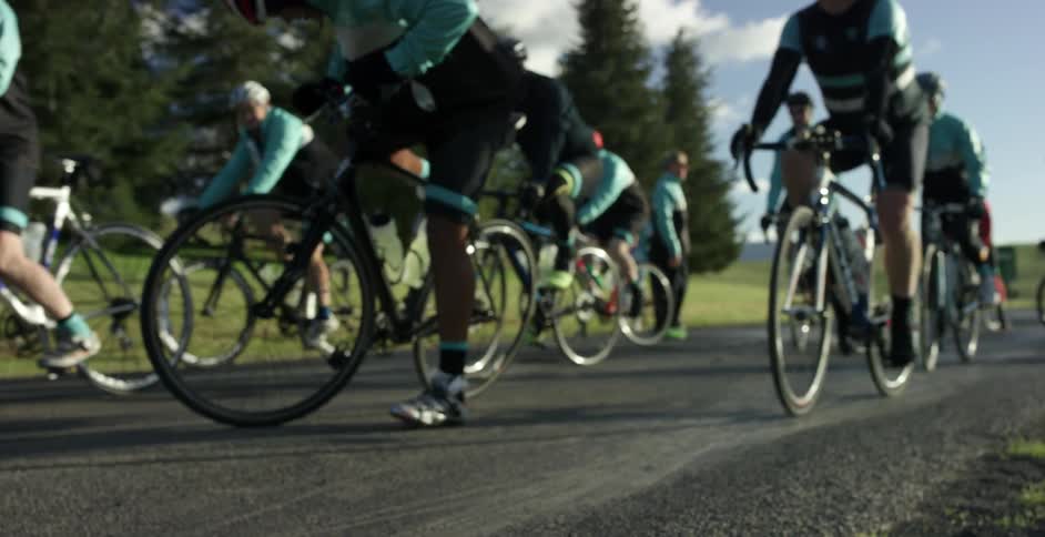Bicyclists ride on a paved path