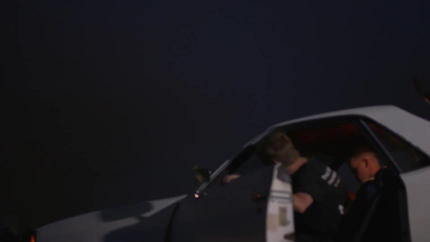 Person opens door of white car and gets in