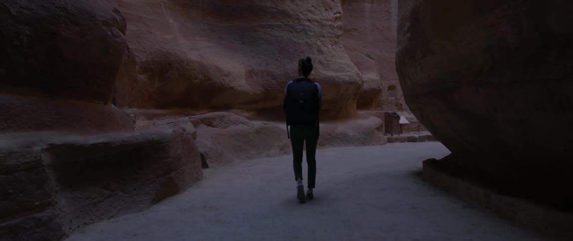 A person walks through a cavern