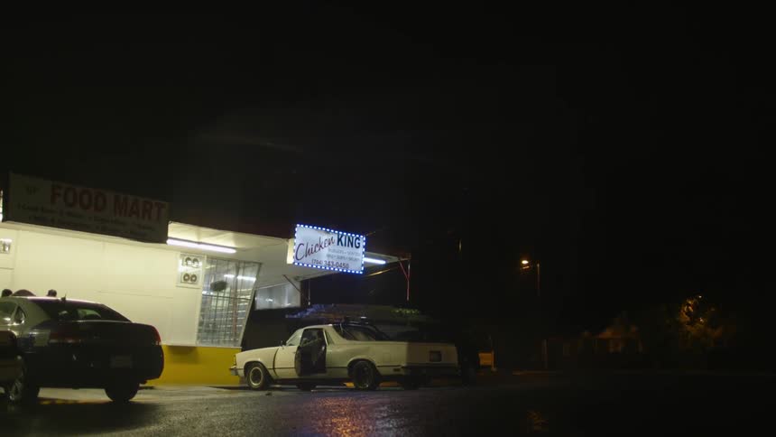 Cars parked outside of a restaurant