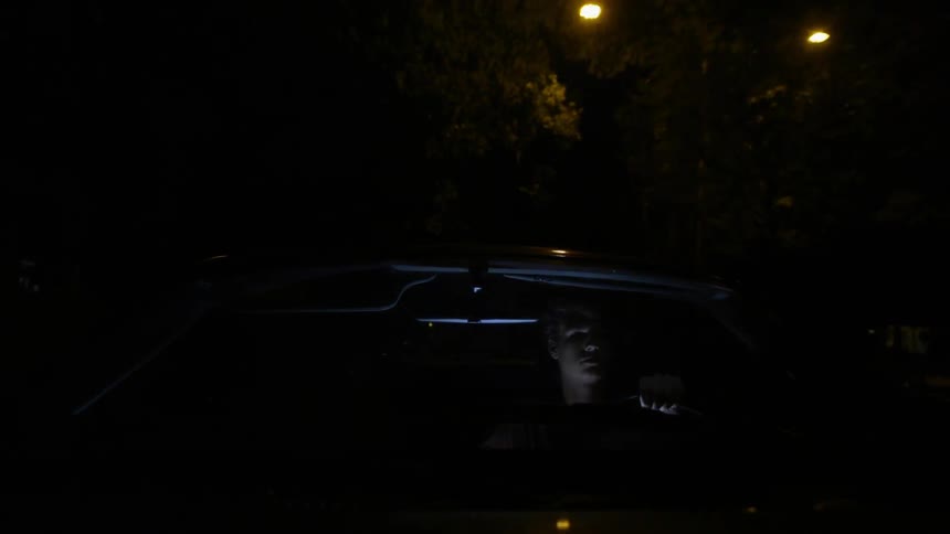 A man drives a car at night