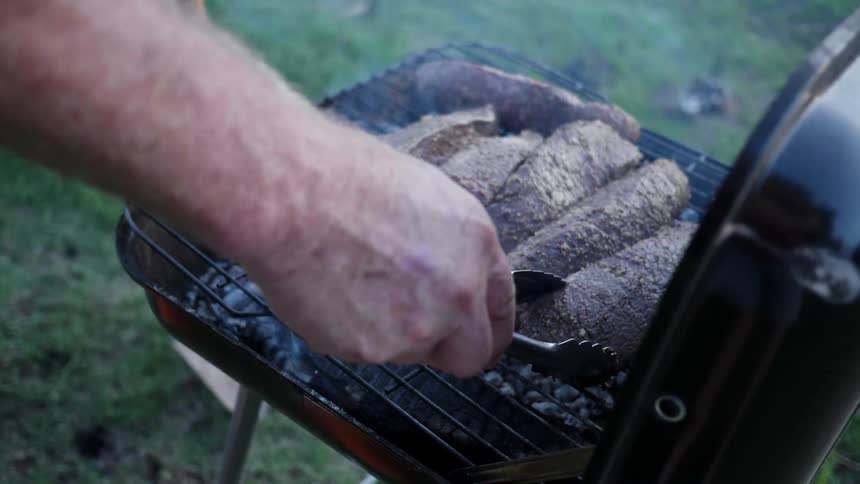 A man cooks on a grill