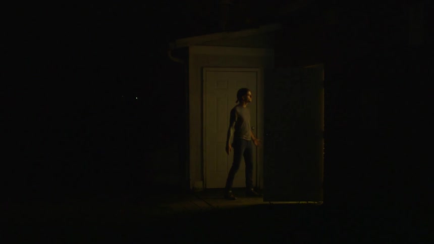 A man walks outside at night