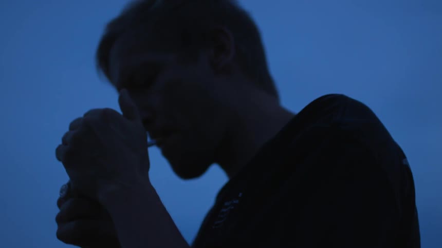 A man lights up a cigarette