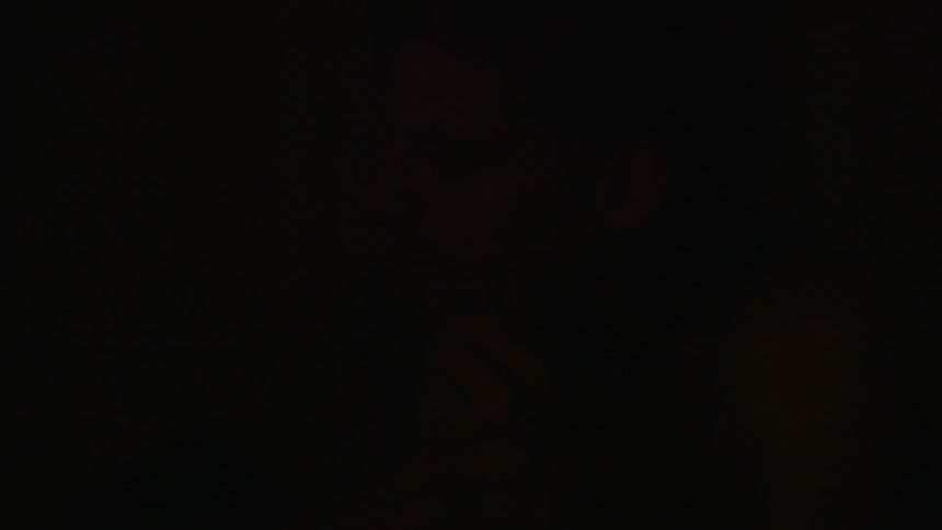 Man sitting in dark and flashing light