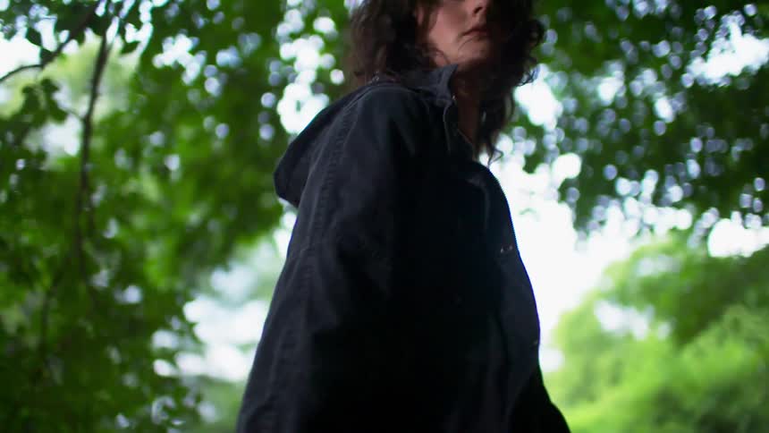 A woman walks outside in the breeze