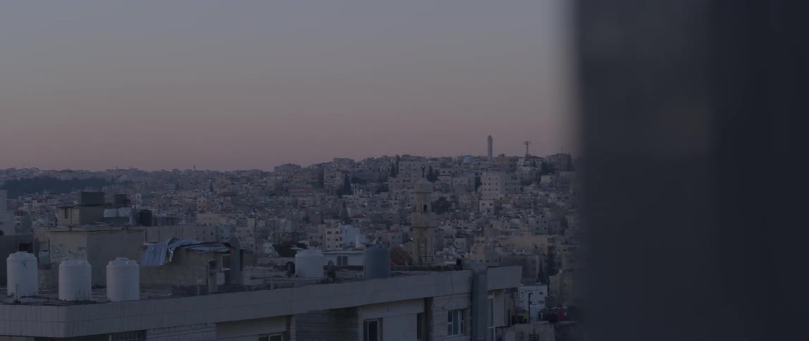 A city is being filmed through a window