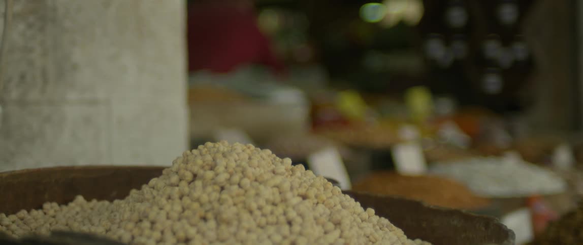 Produce is stacked in a barrel in a street market