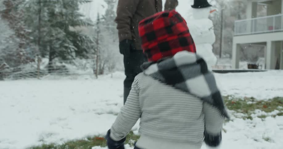 A young child runs in the snow