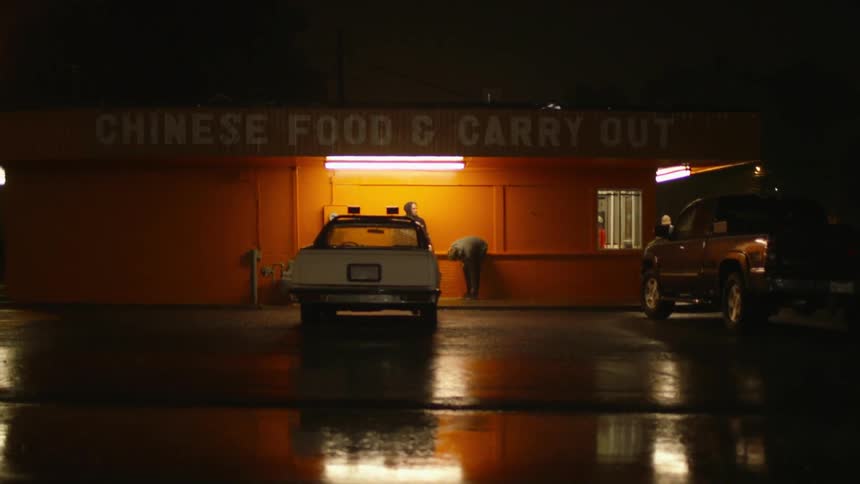 Two men stand in front of a chinese restaurant