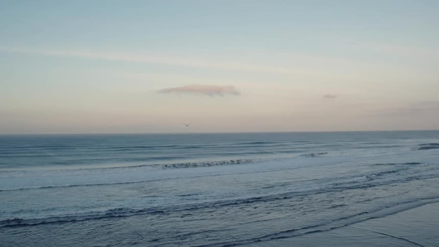 Waves flow onto the beach shore