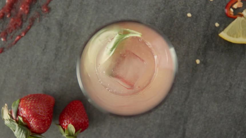 Ice cubes are dropped in a beverage