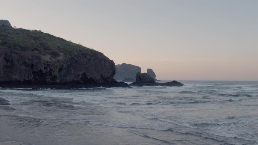 Waves flow onto the beach shore