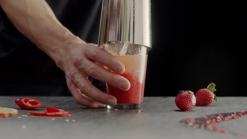 A man mixes a fruit drink